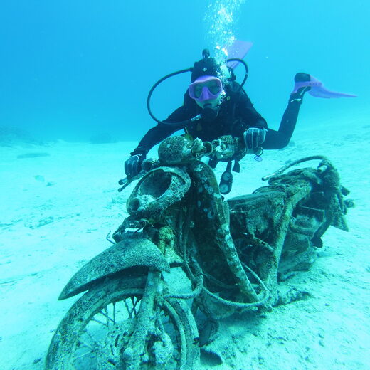 Diver exploring a motorbike wreck